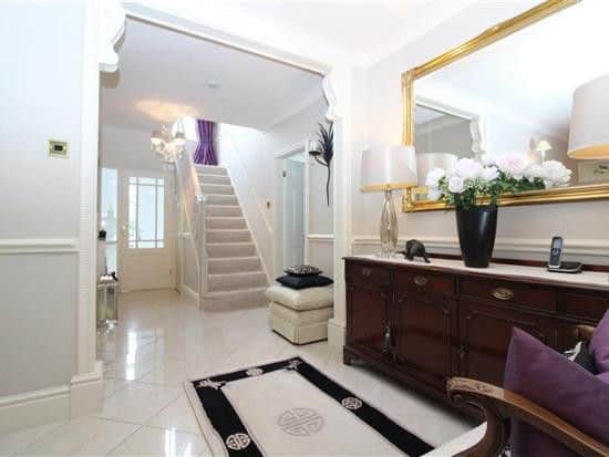 The entrance hall is tiled and leads through to the staircase and the home's main lounge.