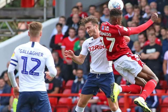 Preston defender Ben Davies challenges Nottingham Forest's Lewis Grabban