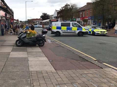 A pedestrian in his 90s was rushed to hospital after a crash in Leyland between a car and a motorcycle.
