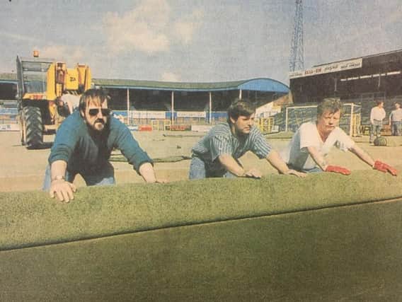 Workmen roll up and remove Preston North Ends plastic pitch at Deepdale in summer 1994