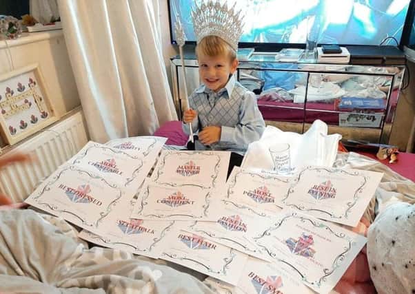 Jayden Fox with all his winning certificates from the Miss Britannia Crystal Master section.