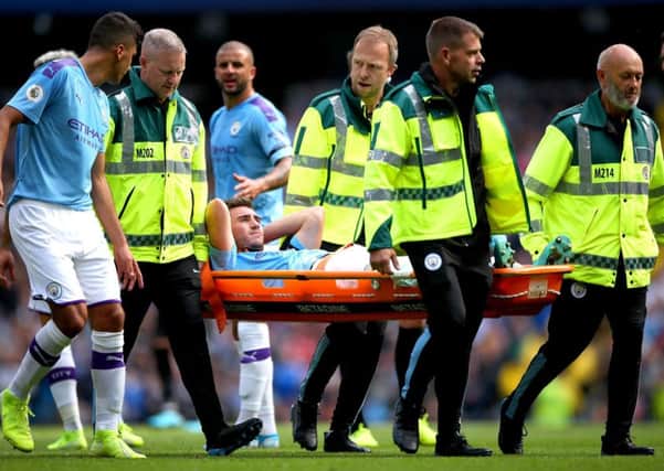 Aymeric Laporte is carried off during City's win against Brighton