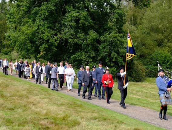 Relatives of the airmen join in a memorial procession, along with dignitaries and members of the armed forces. Picture by Chris Silk