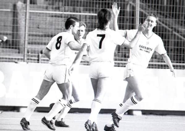 Tony Philliskirk (right) is congratulated by Bruan Mooney (No.7) and Tony Ellis (No.8) after opening the scoring against Brentford