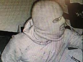 CCTV images show a man armed with a crowbar breaking into a safe into Costa Coffee in Accrington where he stole cash and a laptop