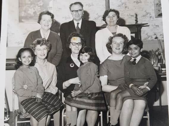 Shakila Kader (now Carter) far left sat on a teachers knee at The Parish Church School, in Preston
Mrs Williams is in the middle
