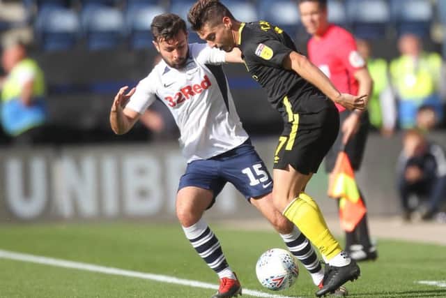Preston left-back Joe Rafferty tussles with Brentford winger Sergi Canos