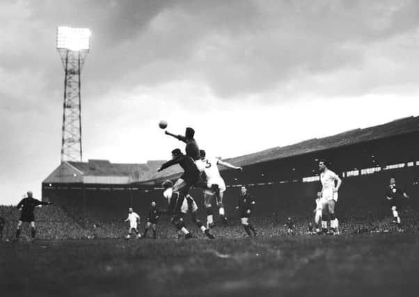 Harry Gregg punches a ball clear against AC Milan in the first leg of the European Cup semi-finals at Old Trafford, in May 1958. United won the match 2-1. (all photos: Getty Images)