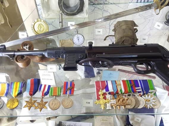 Burden Schmeisser on display in the Lancashire Infantry Museum. Lt Col George Burdens medals, including his DSO and Bar, are in the lower left of the picture