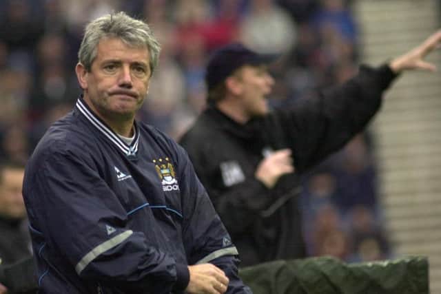 Manchester City manager Kevin Keegan looks rueful on the touchline while PNE boss David Moyes gives out instructions