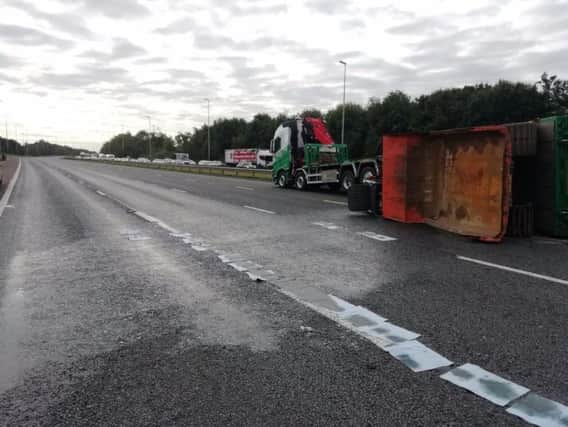 An overturned lorry has spilled around 200 litres of diesel over a half mile stretch of carriageway near junction 31a