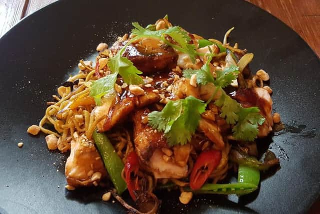 Flaked teriyaki salmon with Singapore-style stir fried noodles and toasted peanuts