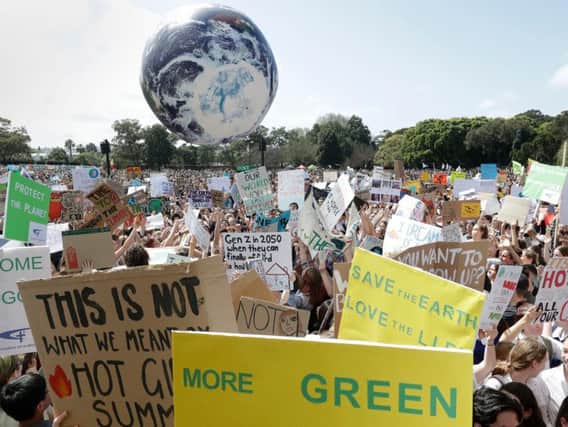 A large inflatable globe is bounced through the crowd as thousands of protestors, many of them school students, gather in Sydney.
Photo: PA