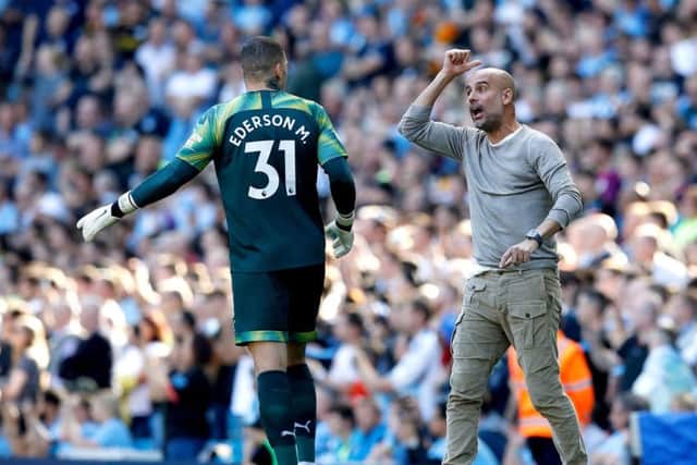 Manchester City boss Pep Guardiola with City goalkeeper Ederson during Saturday's 8-0 win over Watford