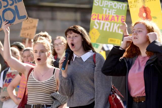 People of all ages gather for a Global Climate Strike protest at Preston Train Station