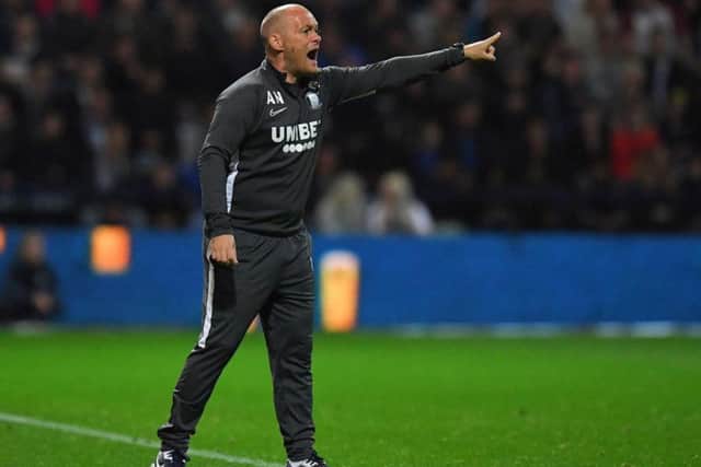 Preston manager Alex Neil gives instructions during the game against Manchester City