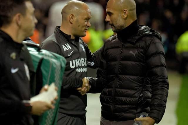 PNE manager Alex Neil shakes hands with his Manchester City counterpart Pep Guardiola