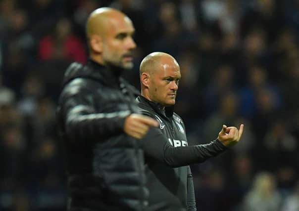 Preston North End manager Alex Neil on the touchline with Manchester City boss Pep Guardiola
