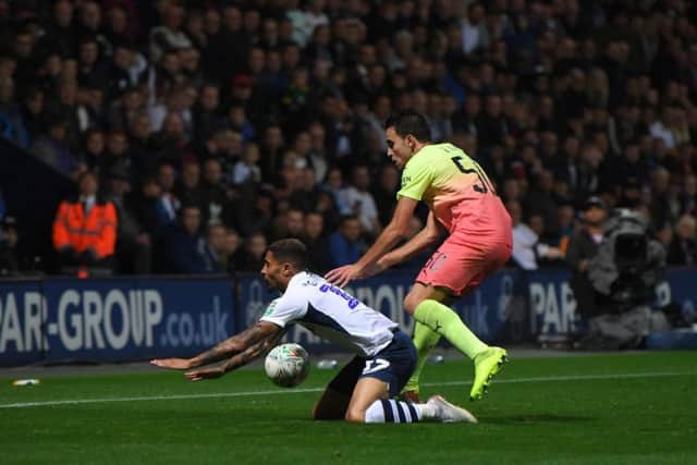 Preston substitute Josh Ginnelly gets a shove from Eric Garcia