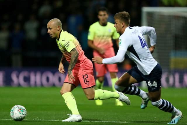 Manchester City's Angelino is chased by Preston midfielder Brad Potts