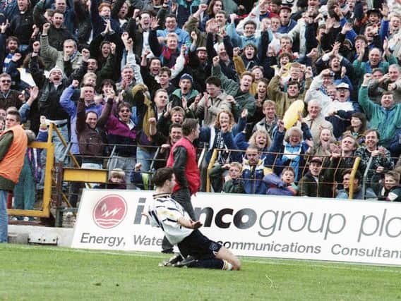 Tony Ellis slides to celebrate his hat-trick in front of the Preston fans at Bloomfield Road in October 1992