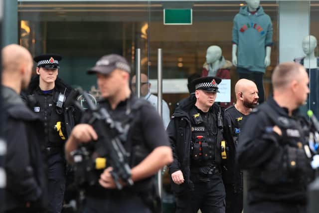 Armed police officers outside the Arndale Centre in Manchester where at least five people have been treated after a stabbing incident. Pic: PA