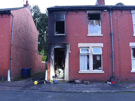 Firefighters are damping down after the blaze took hold of the ground floor entrance hall and first floor of a terraced house on Margaret Road.