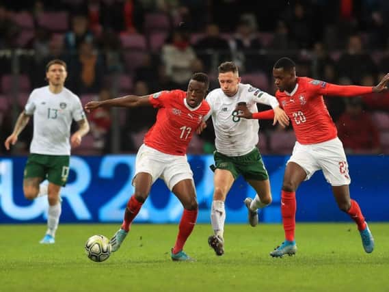 Alan Browne takes on two Switzerland players in the Republic of Ireland's defeat to the Swiss in Geneva