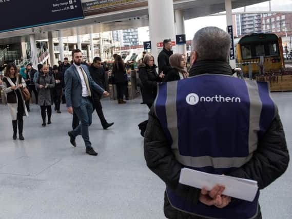 Rail passengers make their way through Manchester Victoria train station