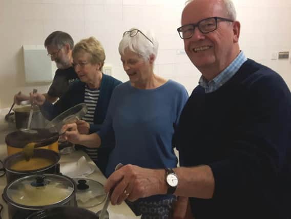 CAFOR parish volunteers prepare homemade soup to be served at the Harvest lunch.