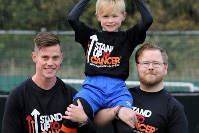 John Farnworth with Daniel Foster and his dad AJ. Photo supplied by Cancer Research UK and taken by Paul Heyes