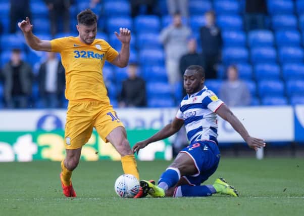 Preston left-back Andrew Hughes is challenged by Reading's Yakou Meite