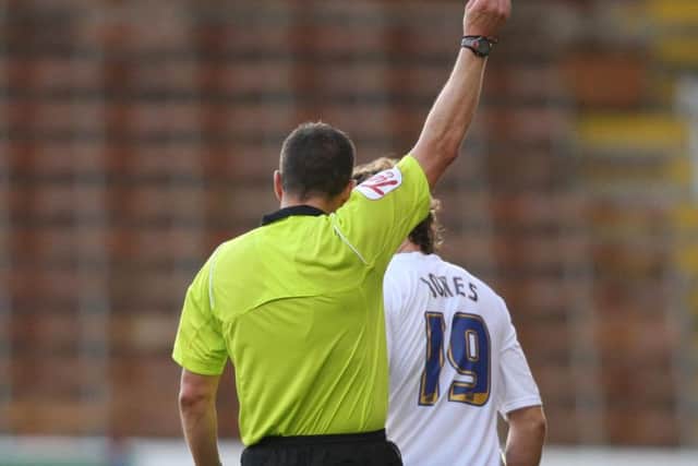 Kevin Friend shows the red card to Preston right-back Billy Jones at Burnley in 2010