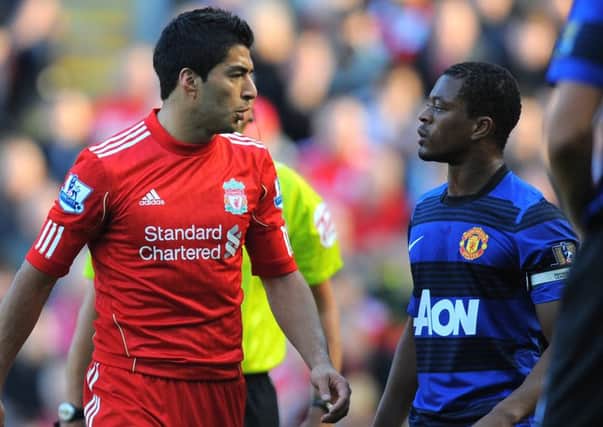 Luis Suarez (left) exchanges words with Patrice Evra during the Premier League clash between Liverpool and Manchester United at Anfield in October 2011 (photo: Getty Images)