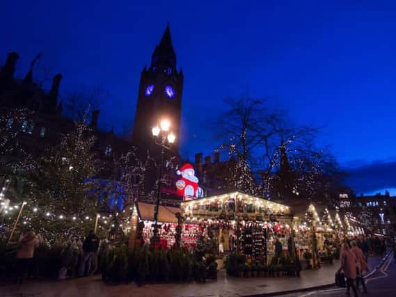 Shoppers Enjoy Manchester's Christmas Market with food stalls. Photo by Richard Stonehouse/Getty Images