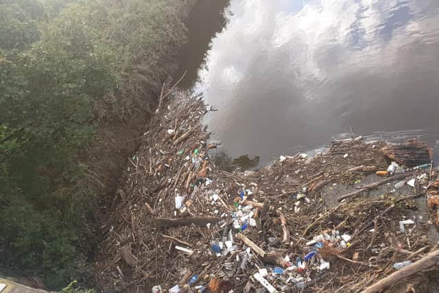 Plastic waste has become tangled in driftwood and dead tree branches in the River Darwen near the Capitol Centre, Walton-le-Dale