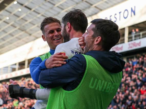 Substitutes Brad Potts and David Nugent celebrate with Tom Barkhuizen after Preston's winning goal against Blackburn
