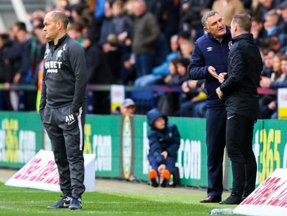 Blackburn manager Tony Mowbray has a word with fourth official Ross Joyce as Alex Neil watches on.