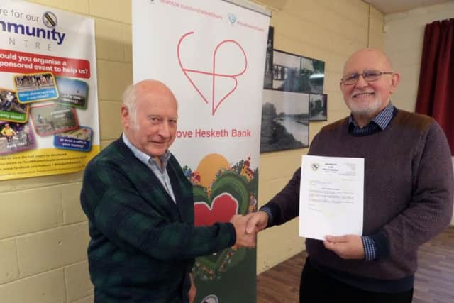 Coun Ron Tyson, representing Hesketh Bank Parish Council, and Mike Ellis, representing Hesketh Bank Community Centre with the letter confirming the grant