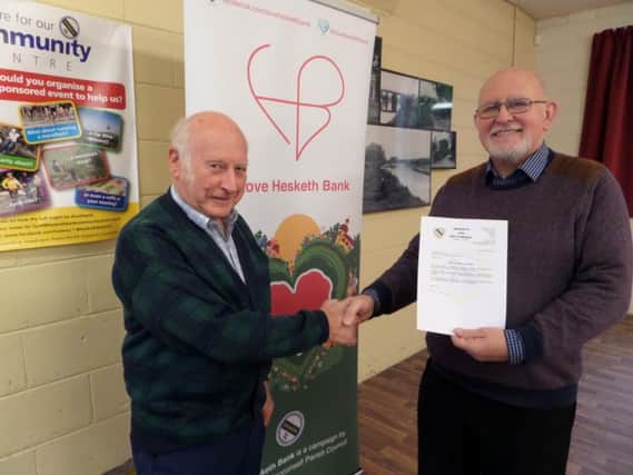Coun Ron Tyson, representing Hesketh Bank Parish Council, and Mike Ellis, representing Hesketh Bank Community Centre with the letter confirming the grant