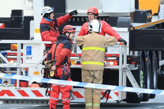 Urban Search and Rescue team members from Lancashire Fire and Rescue Service, prepare to use a hydraulic platform