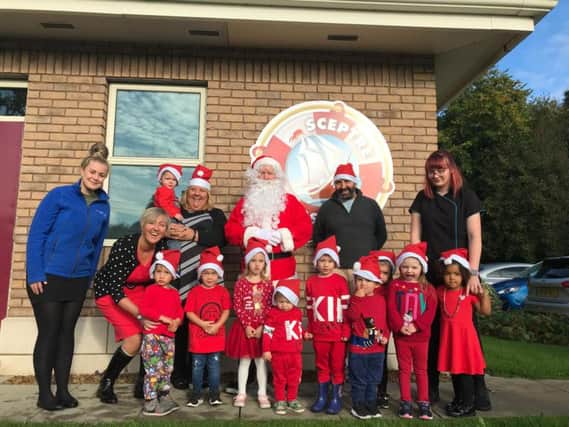 Eric Wright's nursery manager Joanne Pierpoint (left) and nursery nurse Emma Reibbitt (far right) with children who attend Eric Wright Groups on-site nursery. Also supporting the dash are, from the left, Rosemere Cancer Foundations Rebecca Arestidou, Eric Wright Groups Suzanne Taylor and Alan Taylor, who is helping to organise the Cheeky Santa Dash