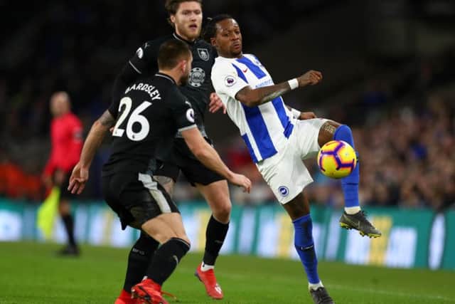 Gaetan Bong of Brighton and Hove Albion battles for possession with Phillip Bardsley and Jeff Hendrick of Burnley during the Premier League match (Photo by Dan Istitene/Getty Images)