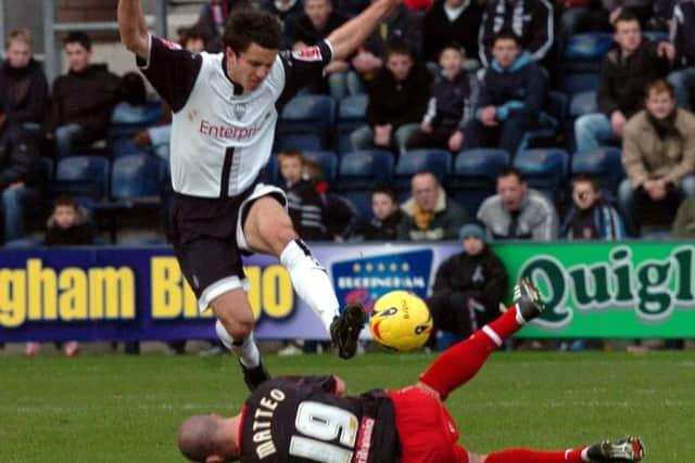 Lewis Neal hurdles a challenge from Dominic Matteo