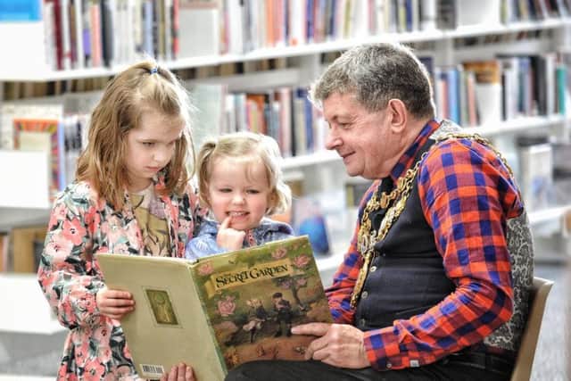 Former Chorley Mayor Mark Perks reads a story to Aurora (6) and Jessica (3) Johnson during the What's Your Story, Chorley? Lit Festival in 2018 (Image: JPIMedia)