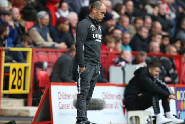 Alex Neil watches on from the technical area at The Valley