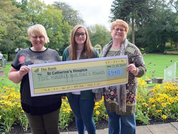 Hazel Atherton and Tracy Jackson, pictured with St Catherines Hospice fundraiser Emily Bate.