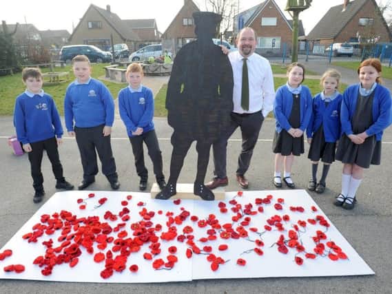 Barnacre Road Primary headteacher Simon Wallis with pupils and some of the many poppies which were knitted for the Longridge schools Armistice Project
