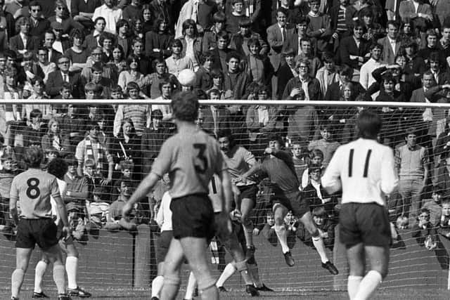 Preston goalkeeper Alan Kelly punches the ball clear against Oxford United