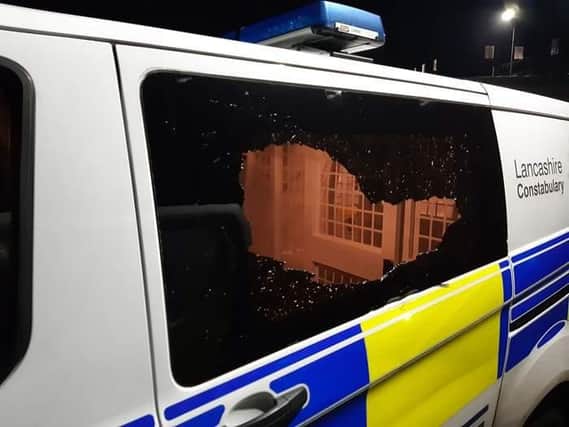Bricks were hurled through the windows of a police van